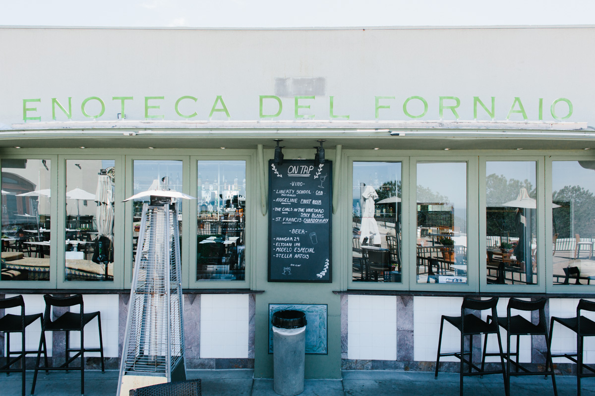 Enoteca Del Fornaio with sign, chair, and outdoors