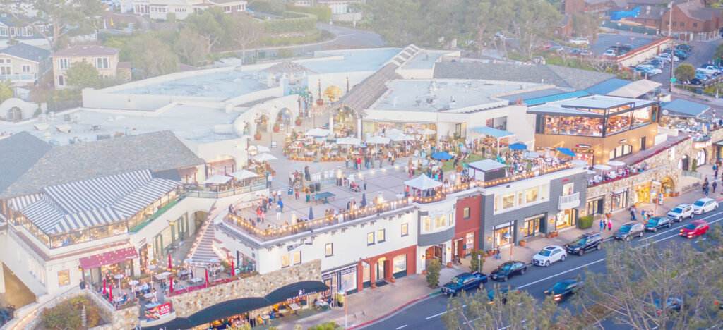 aerial shot of the del mar plaza with a multitude of people hanging out and enjoying the sunshine and shopping